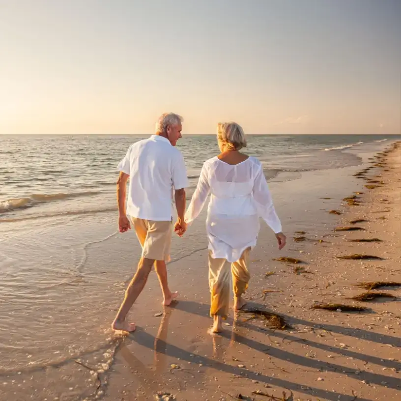 Senior couple walking on the beach