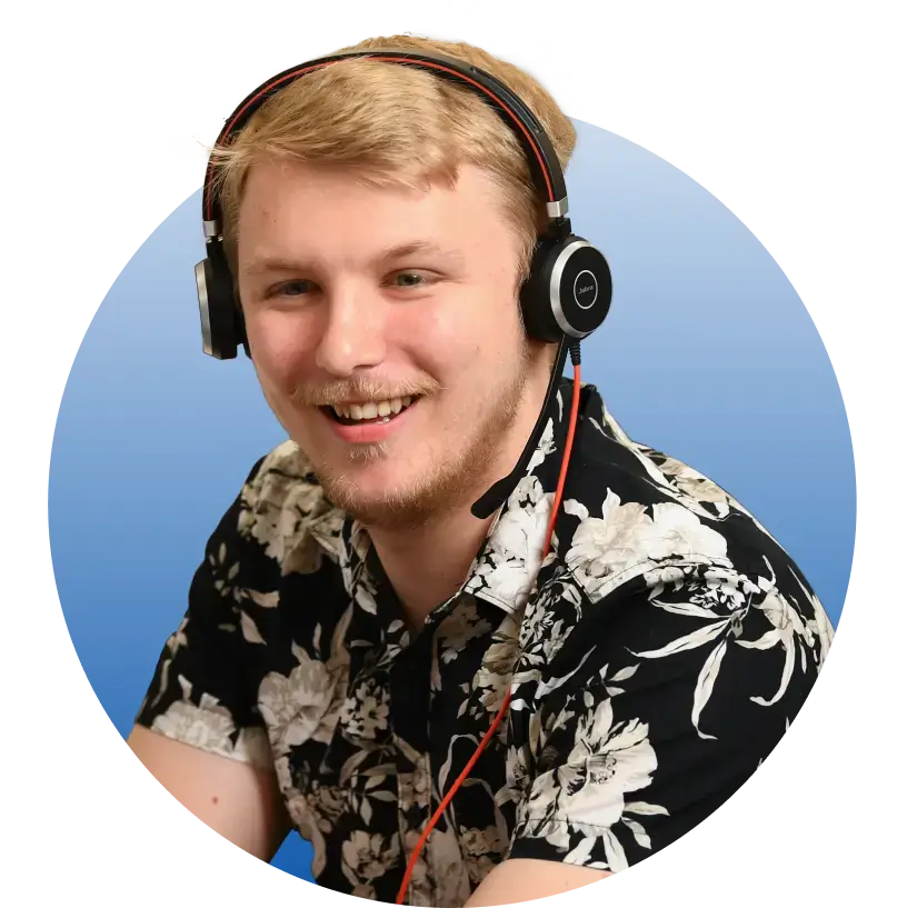 Young man who is a Compare the Market employee, wearing a headset and smiling
